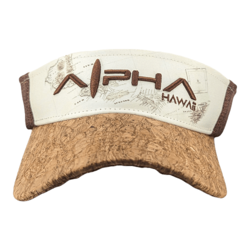 A tan visor cap with a cork-patterned brim and brown trim. The front features the words "Alpha Maui" in large brown letters, with "Hawaii" written in smaller text underneath. A faint map-like design is present in the background behind the text, resembling the Alpha Maui Drop Top Garden Bouquet's aesthetic.