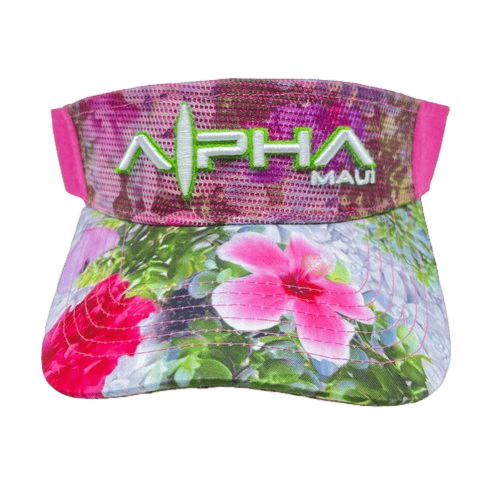 The Alpha Maui Drop Top Garden Bouquet is a vibrant visor adorned with a floral design showcasing pink and white flowers alongside green leaves. The front proudly displays "Alpha Maui" in bold, green letters, separated by an artistic line and dot pattern. The mostly pink background effortlessly captures Hawaii's Aloha spirit.