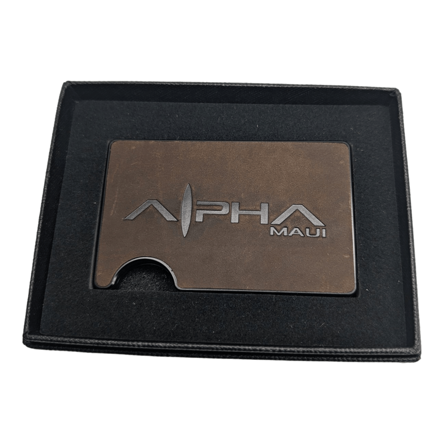 An elegant dark brown metallic card holder featuring the text "Alpha Clip Leather" engraved on it. The card holder is presented in a black box with a luxurious dark lining, making it an ideal gift or presentation item—a perfect accessory for enthusiasts of Hawaii and beach apparel culture.