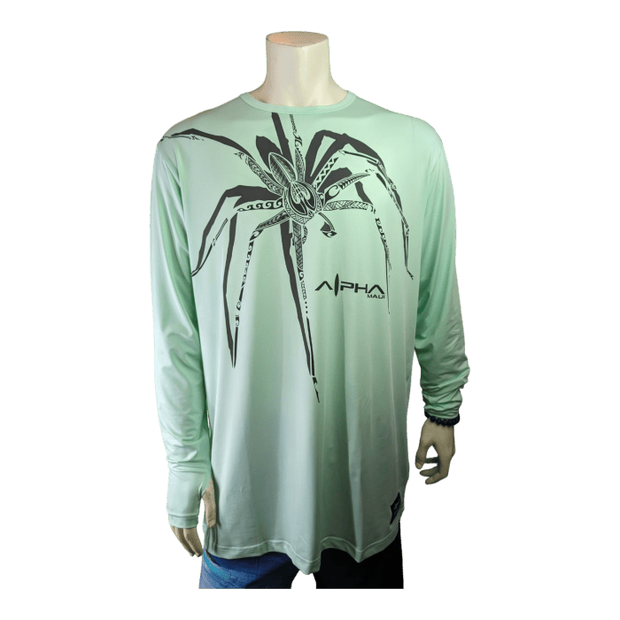 A mannequin sporting an eye-catching Alpha Maui Big Daddy Cane shirt in light green, featuring a long-sleeve design with a prominent black stylized spider on the front. The word "Alpha" is stylishly inscribed on the right side of the chest in black text, adding an extra touch of flair to this unique piece of beachwear.