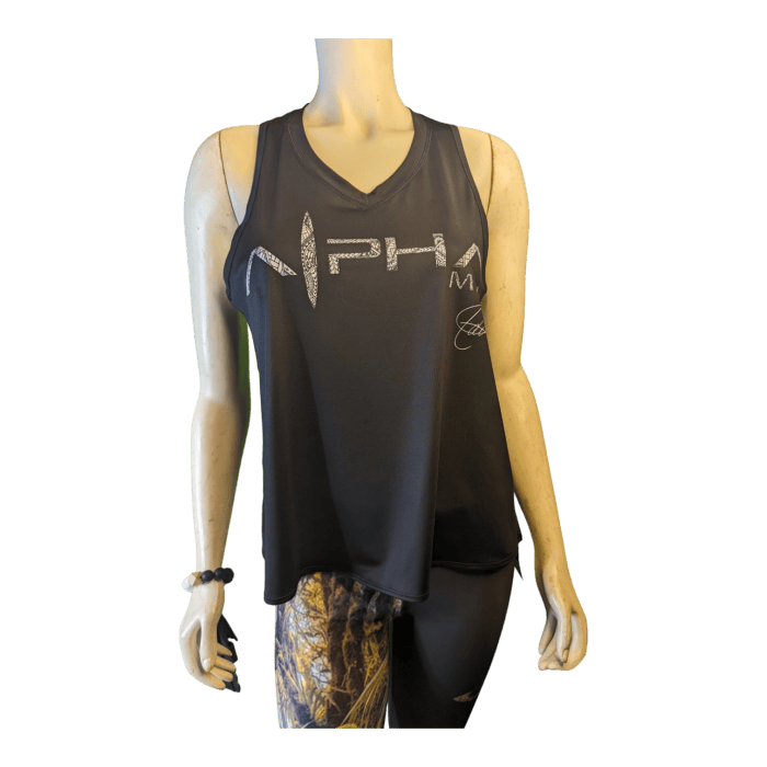 A mannequin is dressed in the Alpha Maui U'i Tank, a black sleeveless top with "NPH" prominently displayed across the chest and smaller text beneath it. The look draws inspiration from Alpha Maui beachwear and features patterned leggings in earthy tones, paired with a green and black beaded bracelet on its left hand.