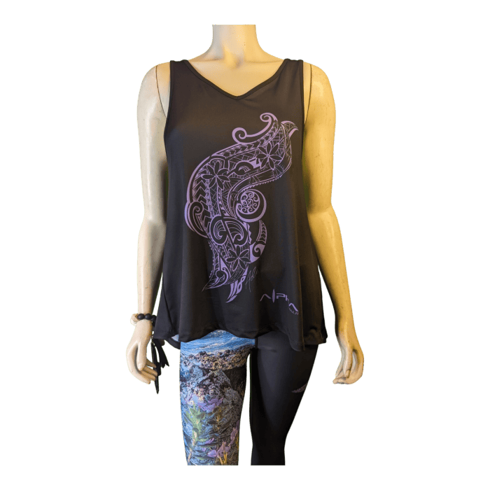 A mannequin dressed in the Alpha Maui U'i Tank, a sleeveless black top featuring an intricate purple design on the front, paired with multicolored leggings, embodies the spirit of Aloha. The outfit, reminiscent of chic beach apparel, stands out against a black background.