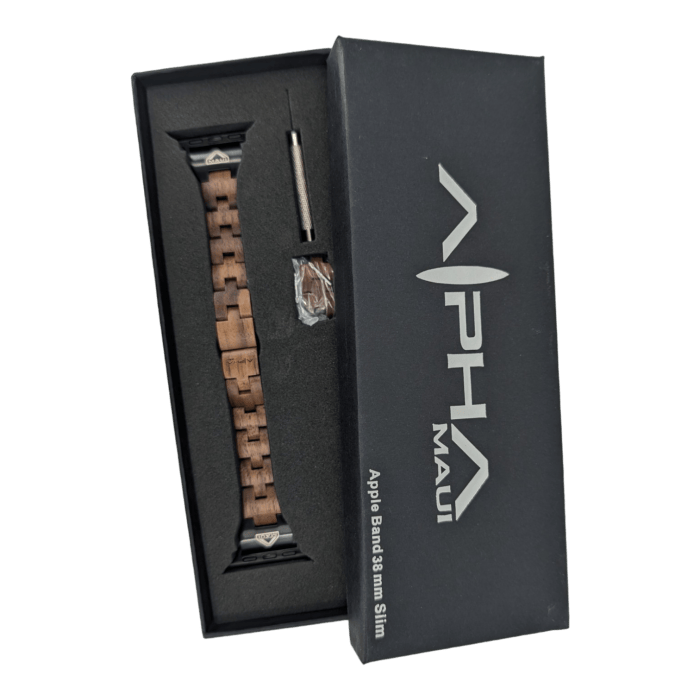 A black box displaying a wooden watch band with a metal clasp labeled "Alpha Maui." The open box contains the watch band in a foam interior, a small screwdriver, and a bag of extra pins. The text "Alpha Maui The Haleakalā 38mm Slim" is printed on the box lid, embracing an Aloha spirit from Hawaii.