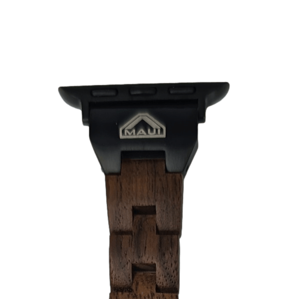 Close-up of an Alpha Maui watch band made of dark wood, featuring a sleek black metal clasp. The clasp bears the Maui logo with the brand name and a triangular icon above it, perfect for complementing your beach apparel.