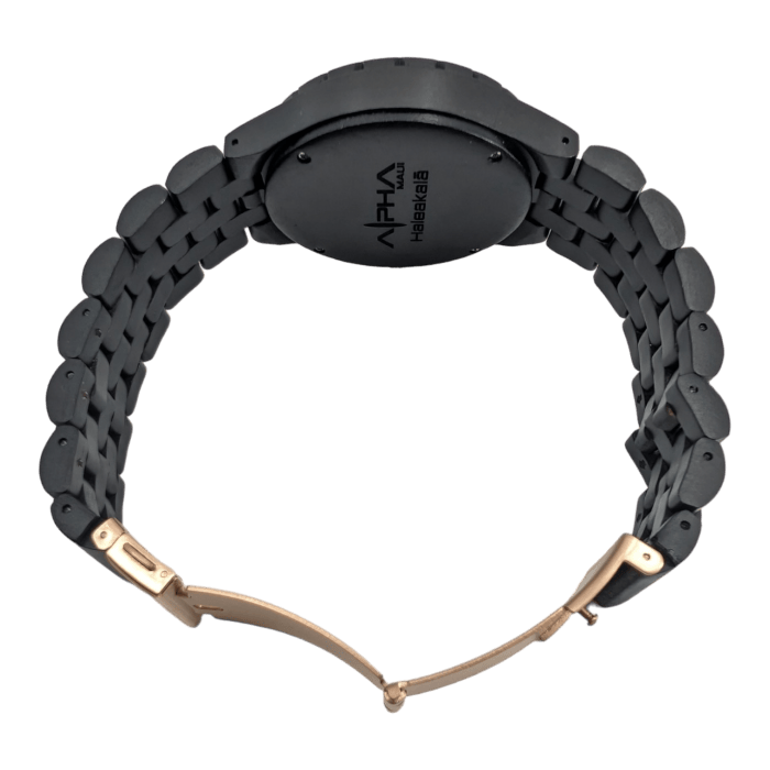 A sleek black wristwatch with a weave-patterned band and a black round case features gold-colored clasp hardware. The back of the watch case is engraved with the brand name "Alpha" and the model "The Haleakalā," embodying an Aloha spirit and Ohana values that evoke Hawaiian elegance.