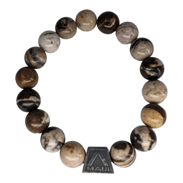 The Alpha Maui The Haleakalā bracelet is crafted from marbled earth-toned stones in shades of brown, white, and black. Featuring round beads and a small rectangular metal charm engraved with "Maui" alongside a triangular design, this circular-shaped accessory embodies the Aloha spirit and is perfect for beachwear.