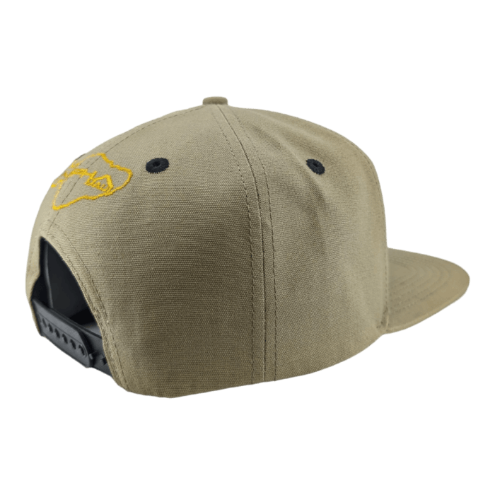 The Alpha Maui Coalition Forces cap, seen from the back, showcases a khaki color with an adjustable strap and a black plastic closure. An intricate yellow embroidered fish design adorns the back panel. Perfect for Hawaii beach outings, the cap features a flat brim and is crafted from sturdy, well-constructed fabric.