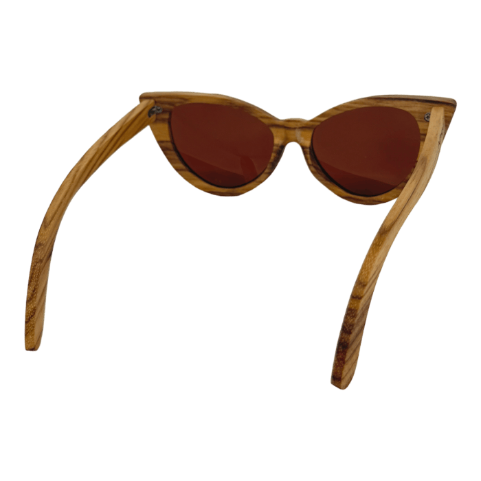 A pair of stylish Alpha Cat Eye sunglasses with a wooden frame and brown-tinted lenses. The frame showcases a polished wood grain texture, and the lenses feature a timeless cat-eye shape. Perfect beach apparel, these Ohana-inspired sunglasses are displayed on a neutral background.