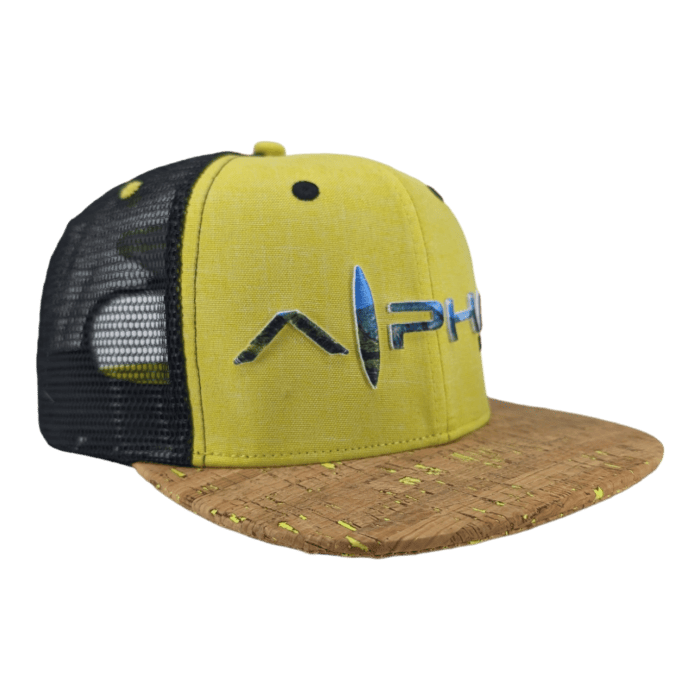 Introducing the Alpha Maui "The Valley Isle": a yellow and black trucker hat featuring a cork brim. The front panel showcases the brand logo "Alphi" in metallic letters, while the side panels are made of black mesh material. It also sports a yellow button on top. Perfect for your next trip to Hawaii or an Ohana gathering, this hat embodies the true Alpha Maui spirit.