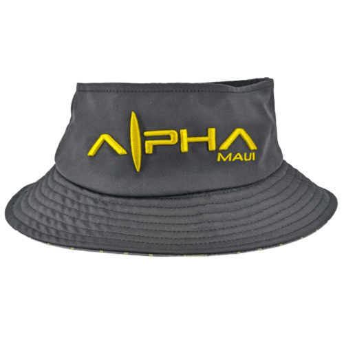 An Alpha Maui Bee Bucks grey bucket hat with yellow embroidery featuring the text "Alpha Maui" alongside a surfboard design. The hat has a soft, flexible brim with subtle stitching details and visible folds. Embrace the Aloha spirit as the text and logo are prominently displayed on the front, evoking the essence of Hawaii.