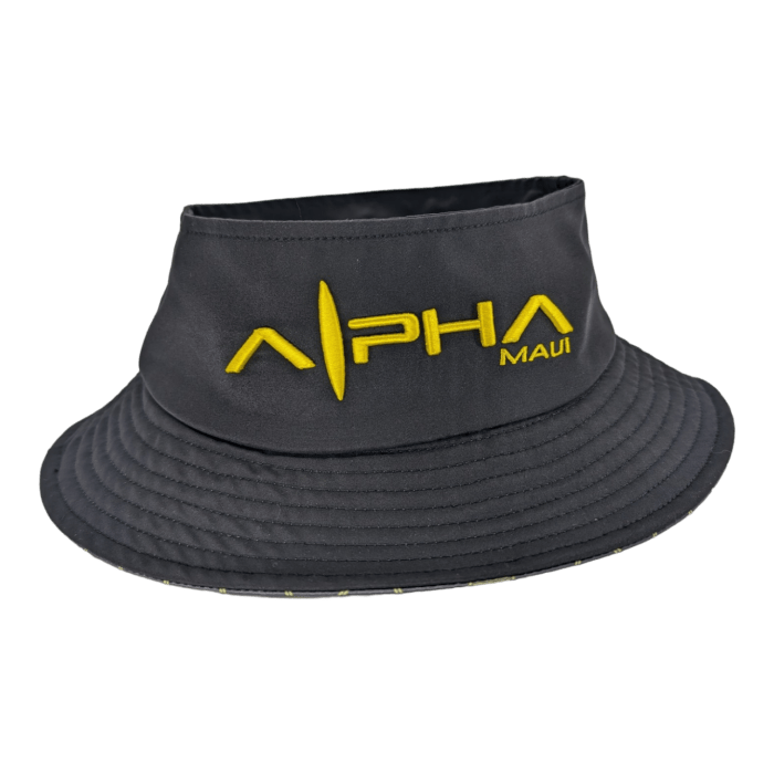 Introducing the "Alpha Maui Bee Bucks," a black bucket hat with a wide brim, perfect for completing your beach apparel. The front showcases intricate yellow embroidery featuring the word "Alpha" in large letters with "Maui" in smaller letters beneath it. The design is further enhanced by a vertical bar splitting the "A" and "L" in "Alpha," symbolizing Hawaii's Ohana spirit.