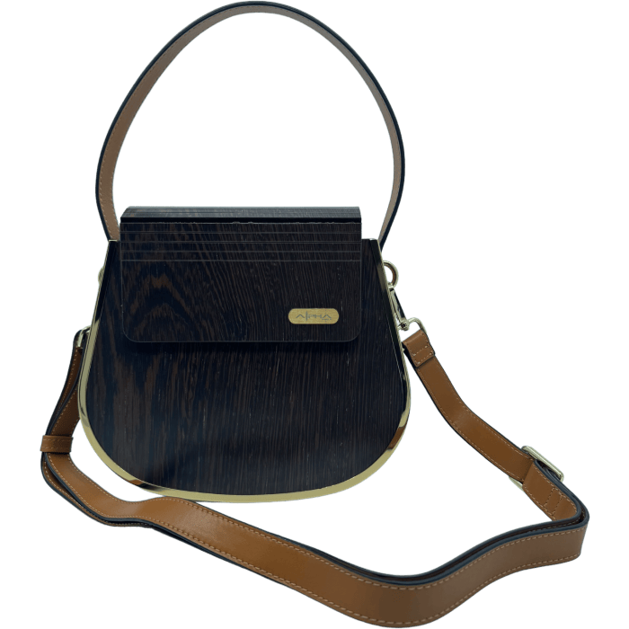 The Alpha Maui Rockit Carrier Purse is a stylish handbag with a dark wooden panel design, featuring a gold accent and a small engraved plate on the front. It has two brown leather straps: a short handle at the top and an adjustable longer shoulder strap. Perfect for pairing with your favorite beach apparel, it boasts a sleek, curved silhouette.