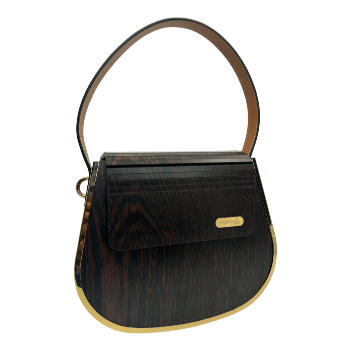 The Alpha Maui Rockit Carrier Purse in black and gold is perfect for complementing your beach apparel, adding a touch of elegance to your Aloha vibe.