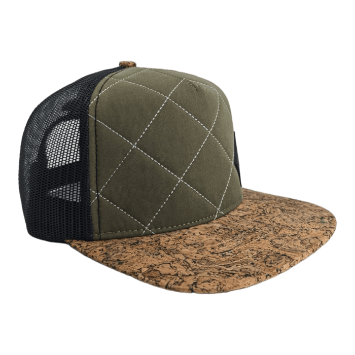 A green trucker hat with white stitching forming a diamond pattern on the front panel. The cap features a black mesh back and a cork brim with a natural textured appearance reminiscent of Hawaii's laid-back Aloha spirit.