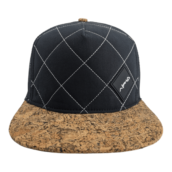 A black cap with white diamond-shaped stitching patterns on the front panel. The cap features a cork-textured flat brim and has a small black rectangular patch with "Aloha" written on it in white letters—perfect beach apparel for your Hawaii adventures.