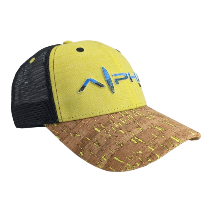 A yellow and black trucker hat with a cork-patterned brim and a blue and green "Alpha" logo in modern font on the front. Perfect for your beach apparel collection, the mesh back ensures ventilation, making it ideal for those sunny Hawaii days.