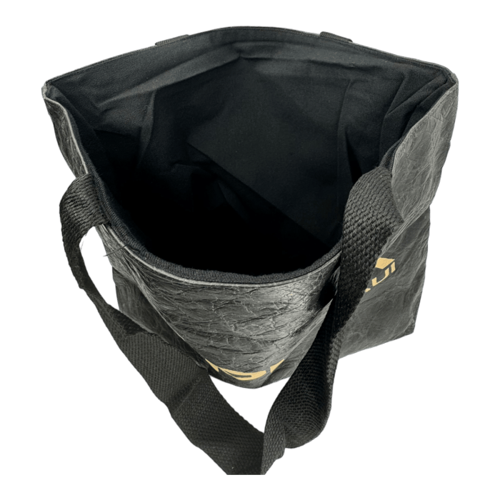 An open black Alpha Maui Dupont Bag with two short handles. The interior of the bag is also black, and the material appears to be textured. Perfect for beach apparel, the bag is standing upright with its top open, revealing its spacious interior.