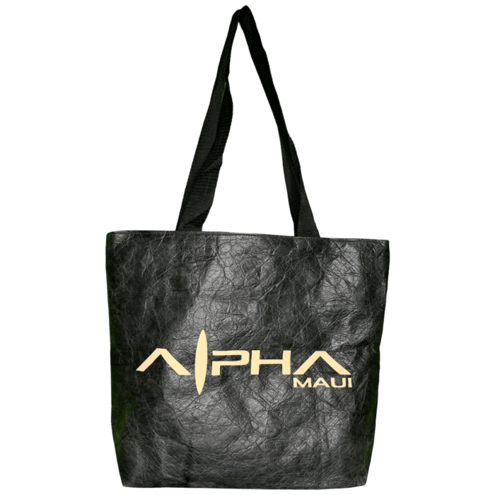 Introducing the Alpha Maui Dupont Bag, a stylish black textured tote with sleek black handles, ideal for complementing your beach attire. Featuring "Alpha Maui" in striking gold letters on one side, this bag infuses a touch of Aloha spirit into your summer outings.