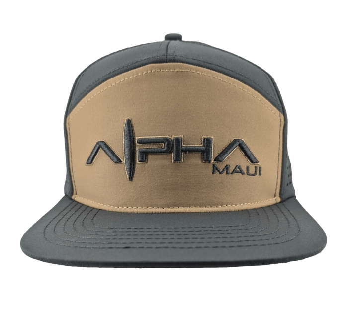 Introducing the Hydro Hunter, a stylish two-tone baseball cap that features "Alpha Maui" in large black embroidered letters and "Ohana" in smaller black letters on the front. The cap boasts a grey bill and sides, with a tan front panel. A triangular logo is elegantly placed between "Alpha Maui," making this hat a perfect addition to your wardrobe that brings a touch of Hawaii to any outfit.