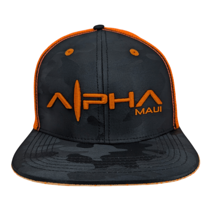 A Lava Loaded baseball cap designed in black and dark gray camouflage features the text "ALPHA MAUI" embroidered in bright orange on the front. The cap is adorned with an orange lining around the brim and outer edges of the front panels.