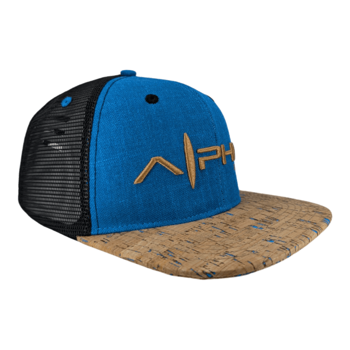 Introducing The Coastline, a blue and black trucker hat with a mesh back. The front panel of the hat showcases the word "Alpha" in yellow lettering. Its brim sports a light brown, cork-like texture accented with blue lines. The hat is displayed against a black background.