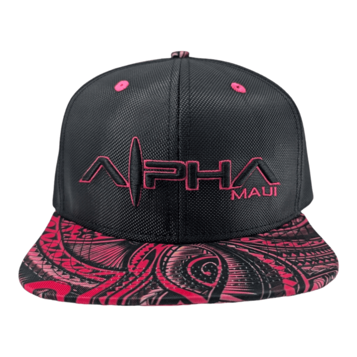 Introducing the Tribal Wai: a black snapback cap with a vibrant, intricately designed red and pink patterned brim. The front of the cap features the text "ALPHA MAUI" embroidered in bright pink letters.