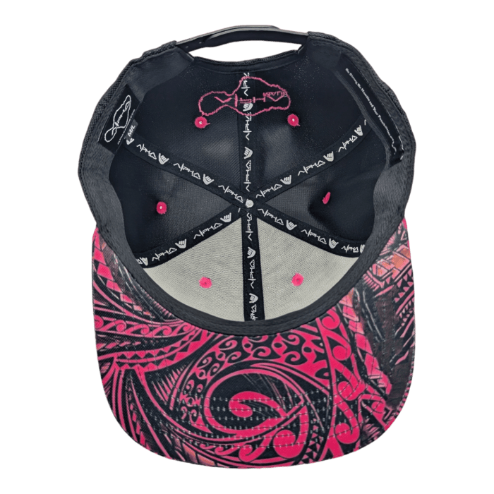 The Tribal Wai baseball cap is showcased from the underside, highlighting its distinctive design. The interior boasts pink accents and a black lining adorned with white patterns, while the visor features elaborate pink and black tribal-style artwork.