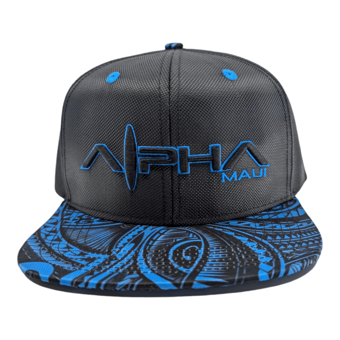 The "Tribal Wai" cap is a black baseball cap with a blue and black geometric patterned brim, featuring the text "ALPHA MAUI" embroidered in blue on the front. The brim showcases a detailed, intricate design, while the rest of the cap has a solid black background.