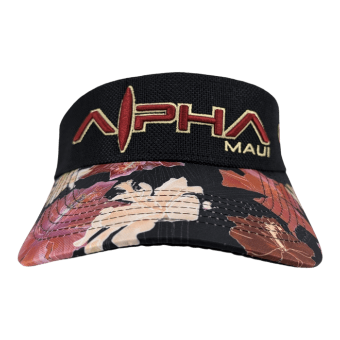 A Drop Top Hibiscus black visor cap with a floral-patterned brim. The front of the visor features the embroidered text "ALPHA MAUI" in red and yellow letters.