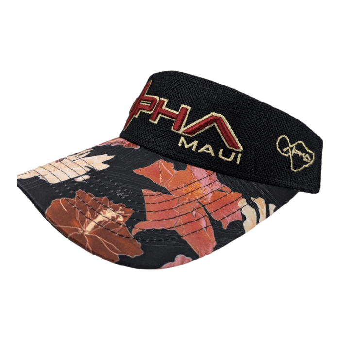 The Drop Top Hibiscus visor showcases a black design with a floral-patterned brim in shades of pink and orange. The band is adorned with red and gold embroidered text that reads "Alpha Maui" and features a small gold outline of the Hawaiian Islands.