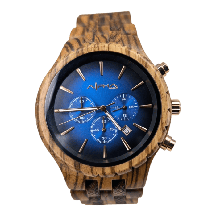 Introducing The Voyager: a stylish wristwatch featuring a wooden band and case. Its watch face transitions from dark blue to lighter blue toward the center, showcasing three sub-dials for chronograph functions. The elegant design is complemented by rose gold hour markers and hands, with the brand name "Alpha" displayed just below the 12 o'clock position.