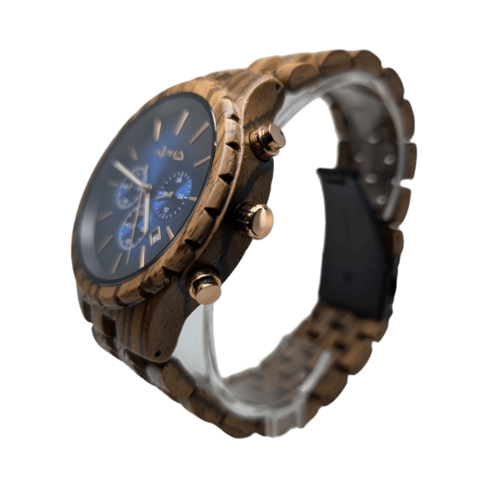 The Voyager is a wooden wristwatch characterized by a dark brown grain and a black dial adorned with blue accents and three subdials. It features bronze buttons on the side, a transparent band clasp, and bronze-colored watch hands and markers.