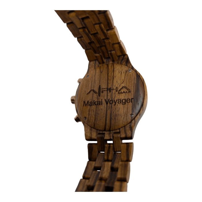 The Voyger is a wooden wristwatch featuring a dark brown, linked band. The back of the watch is engraved with a logo and the text "Makai Voyager." The visible grain and texture of the wood highlight the craftsmanship of this piece. Additionally, it has side buttons for adjustment.