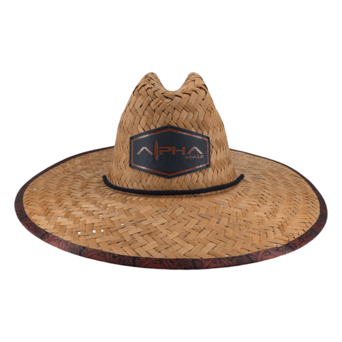 The Autumn Sunrise is a wide-brimmed, straw sun hat featuring a decorative band around the brim and a black logo patch on the front that reads "APHA MAUI." It boasts a high crown with a pinched crease at the top and includes a chin strap. The background is black.