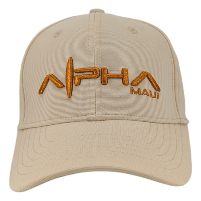 The Autumn Sunrise is a beige baseball cap that features "ALPHA MAUI" embroidered in gold capital letters on the front, including a distinctive stylized "A" with a line running through the middle. It has a curved brim and detailed stitching.