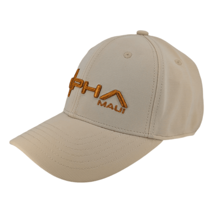 A baseball cap in beige, featuring orange embroidered text reading "Alpha Maui" on the front. The letters "A" and "L" in "Alpha" are uniquely stylized, with the "L" resembling a roof. Made from textured fabric, this cap includes six ventilation eyelets for breathability. Its name is Autumn Sunrise.