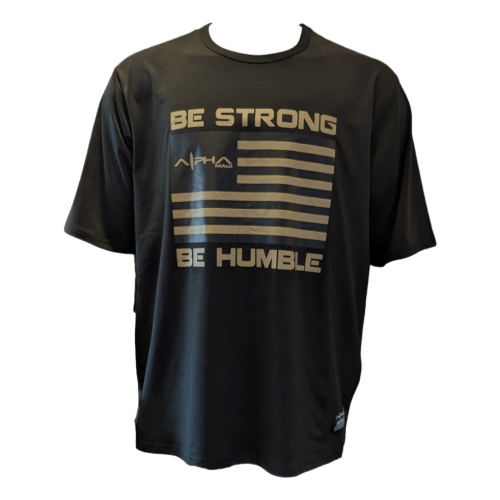 Be Strong Be Humble" black t-shirt features gold text and graphic with "BE STRONG BE HUMBLE" around a stylized American flag and "ALPHA" above the flag.